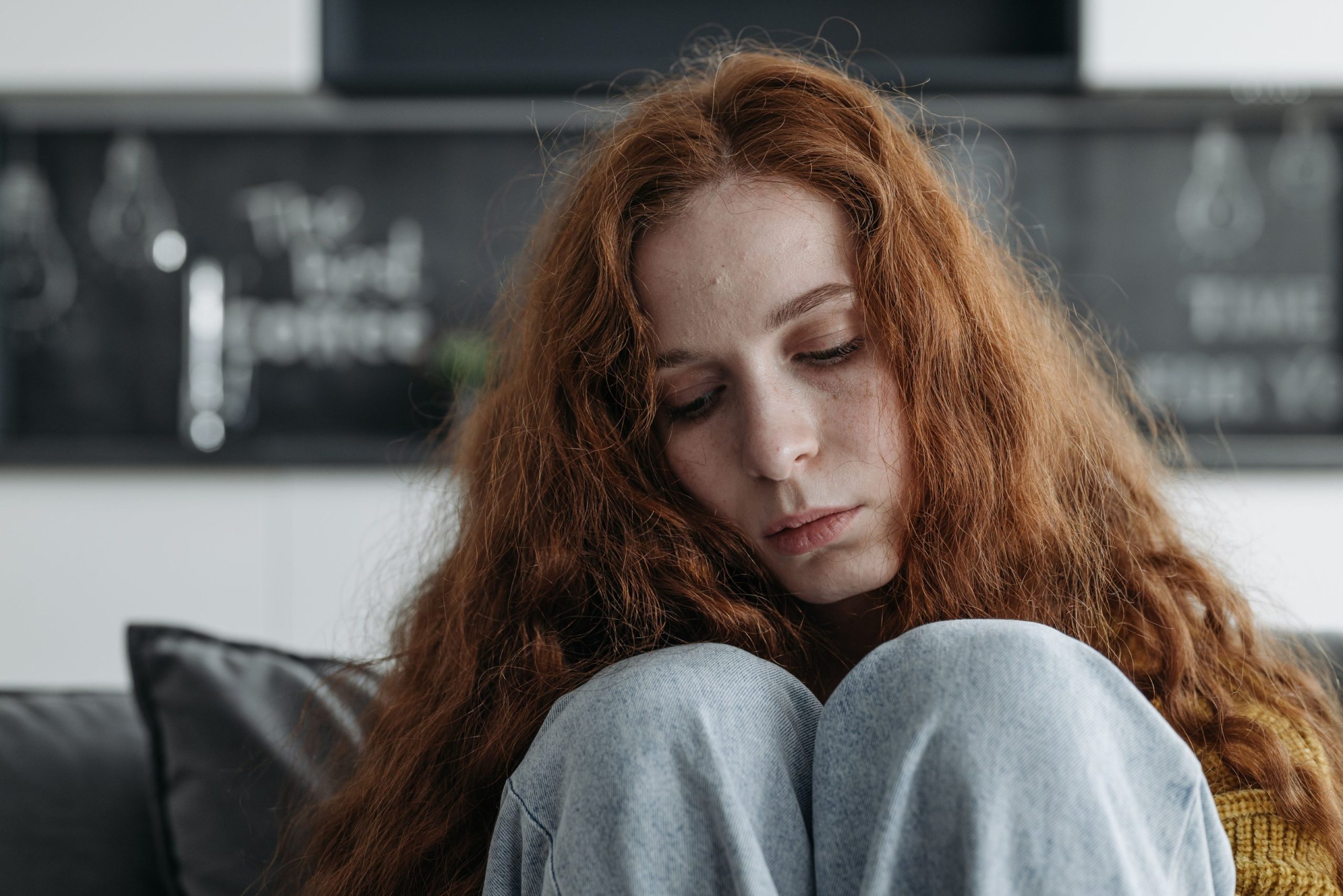 A woman looking down and in despair identity loss in toxic relationships
